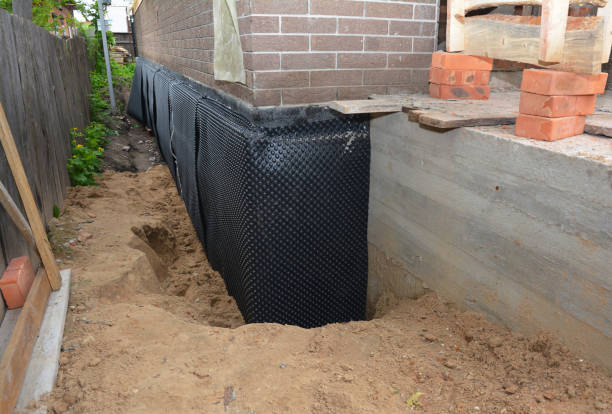 Happy homeowners after waterproofing job in Alma